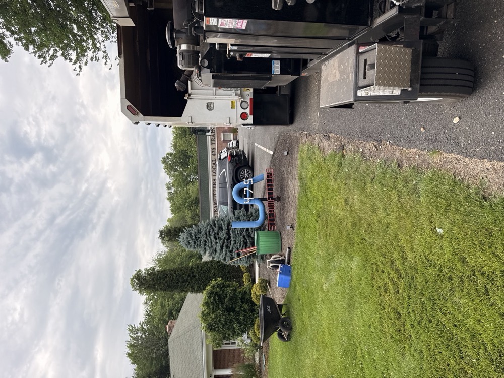 Chipper truck at the curb during a residential cleanup