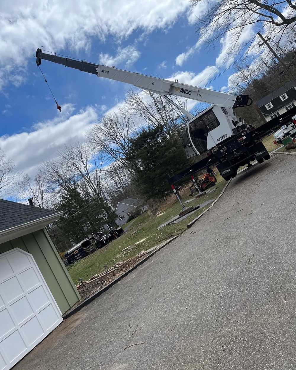 Crane truck set up on a residential driveway